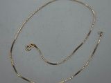 a gold chain with a clasp on a white background