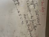 a person holding a piece of paper with writing on it