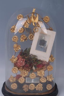 a glass clochet with a picture of a man under it