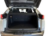 the back of a silver suv with its trunk open