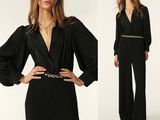 the woman is wearing a black jumpsuit with a belt