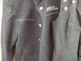 jacket and pants are hanging on a hanger on a wall