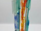 a glass sculpture of a tower with a bird perched on top of it