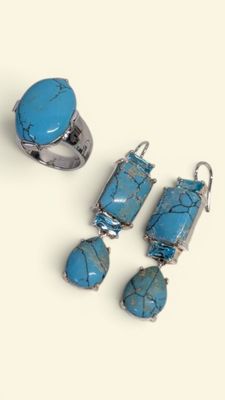 three pieces of jewelry including a turquoise stone ring, earrings, and ring