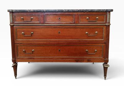an antique chest of drawers with marble top