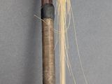 a long wooden stick with a long stick sticking out of it