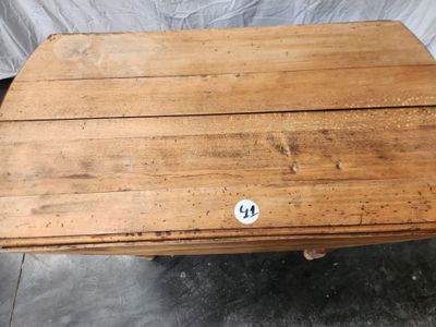 an old wooden table with a sticker on the top of it