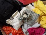 a box full of clothes and a backpack sitting on the floor