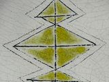 a white plate with a yellow and black design on it