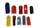 seven pairs of shoes that are lined up on a white surface