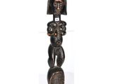 an image of a wooden sculpture of a woman holding a child
