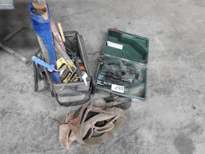 a box of tools sitting on the floor next to a pair of shoes