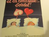une affiche représentant un couple au lit, avec un cœur au milieu