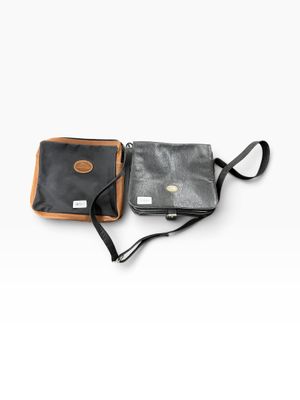 two pieces of black and brown leather on a white background