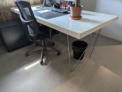 a desk with a chair and a computer on it