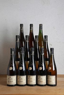 many bottles of wine sitting on a wooden table