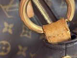 a close up of a brown bag with a gold ring