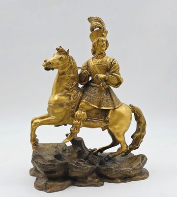 figurine en bronze représentant un homme à cheval sur un rocher