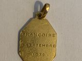 a close up of a gold coin on a white surface