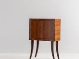 a small wooden cabinet with two drawers and two legs