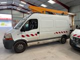 two vans parked in a warehouse with a crane on top of them