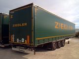 a green semi truck that is parked in a parking lot