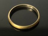 a close up of a gold ring on a black surface