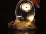 a glass ball with a clock inside of it on a table