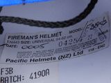 a label on the back of a helmet that says fireman ' s helmet