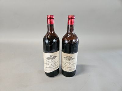 two bottles of wine sitting next to each other on a table