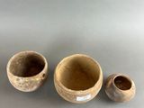 a set of three small ceramic bowls and a smaller ceramic bowl