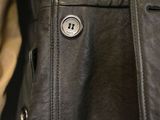 the back of a leather jacket with buttons on it