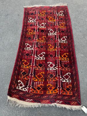 a red and black rug with a pattern on it