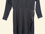 the dress is black and has a long sleeve and a side tie