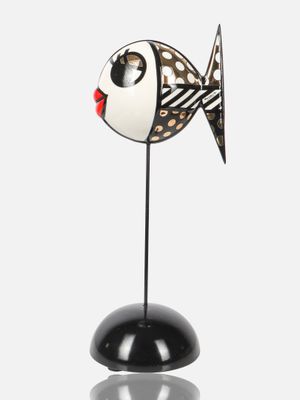 an image of a black and white fish figurine on a black base