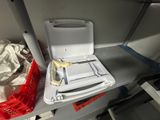 a white toilet sitting on top of a metal shelf