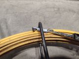 a yellow hose and a black hose on the floor