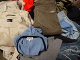 a pile of clothes that is sitting on the floor