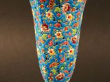 une image représentant un vase bleu orné d'un motif floral