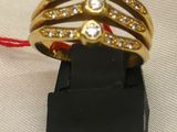 a gold ring with diamonds on it on a black stand