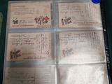 a lot of old postcards on display in a glass case