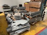 a large pile of metal in a warehouse with pallets and boxes