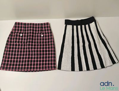 two skirts are lined up on a white surface