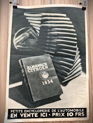 a black and white photo of a book and a stack of books
