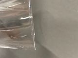 a person pouring something into a glass on the counter