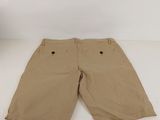 the children ' s khaki shorts are tan and have buttons on the front