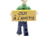 a figurine of a boy holding a sign that says oh al amitie