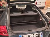 a car with its trunk open in a garage