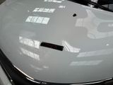 a close up of a car ' s hood with a sticker on it