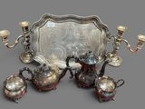 a silver tray with a silver tea set on top of it